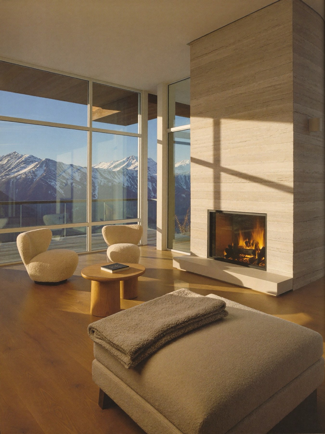 Immaculate luxury great room with fireplace and snowy mountain views
